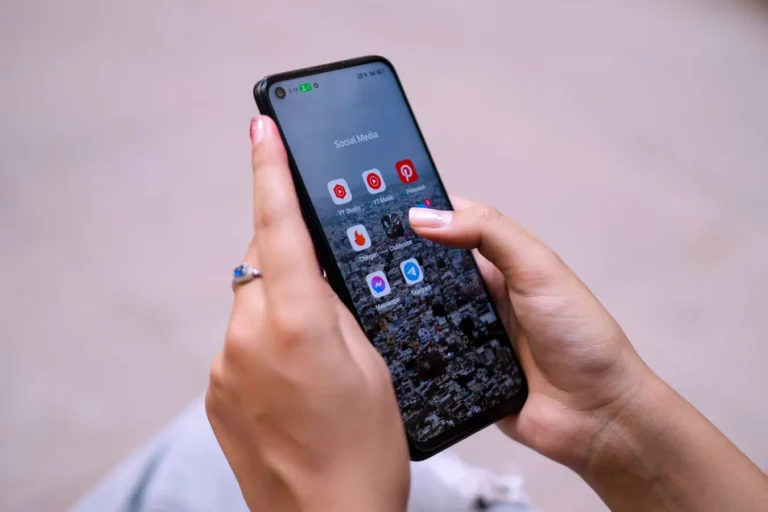 Hands holding a smartphone with social media apps, highlighting Instagram account access and digital connectivity