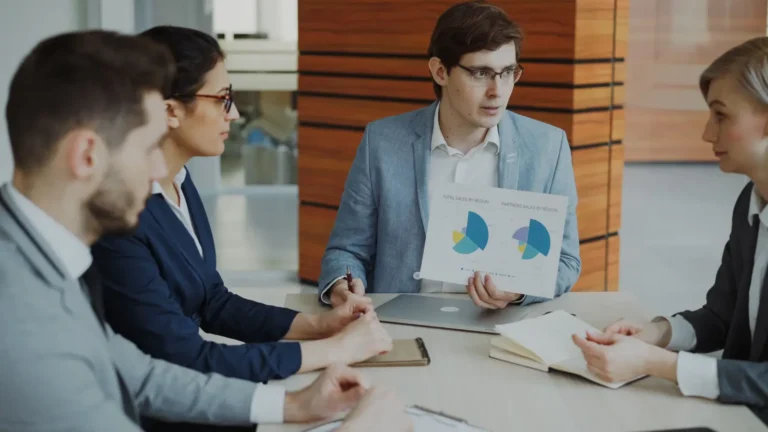 Professionals reviewing charts in a business meeting about agile CRM software decisions
