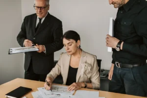 Business professionals reviewing financial documents in an office, discussing project management software options