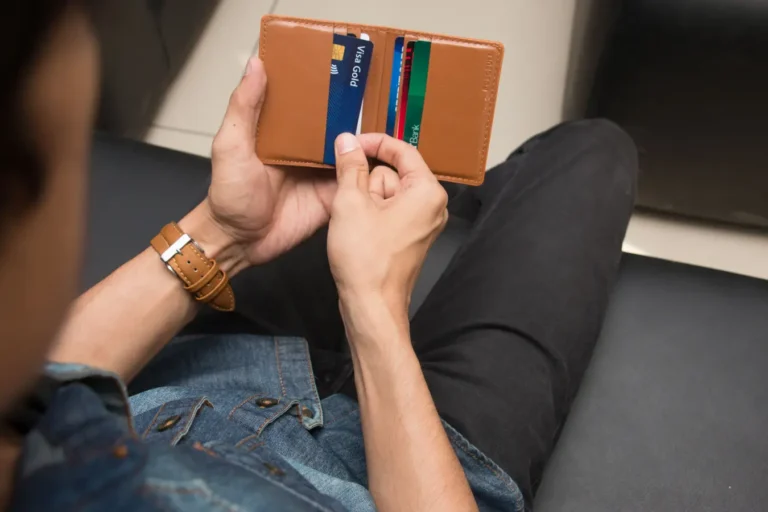 Man holding a wallet with different credit cards in India for everyday spending