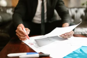 Businessman reviewing financial documents at office desk, illustrating DSCR loan meaning in mortgage lending