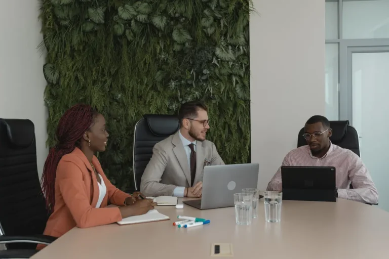 Diverse team collaborating in a modern office with a vertical garden, reflecting ESG investing themes