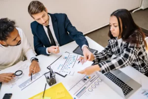 Business professionals reviewing charts and documents in a collaborative meeting on ESG investing private equity