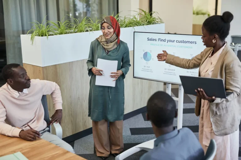 Team of professionals discussing sales strategy for example CRM software in a modern office