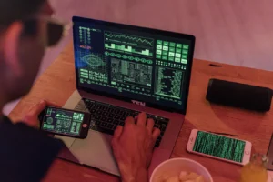 Man using laptop and smartphone with cybersecurity software for Google Workspace password manager security