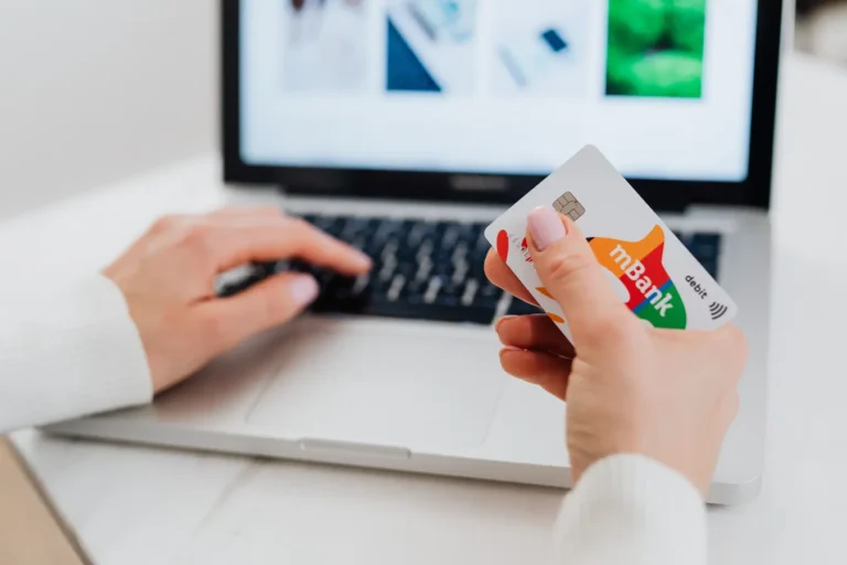 Hands using a laptop and credit card for secure HDFC credit card login online