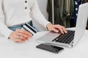 Person using a laptop for online shopping while holding a credit card