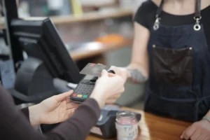 Customer and cashier completing a Home Depot credit card transaction at an indoor store counter