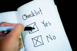 Close-up of a notebook checklist with a marked Yes box, suggesting value-based decision making