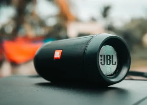 Black JBL portable Bluetooth speaker on a surface, suitable for JBL Bluetooth speakers with mic article