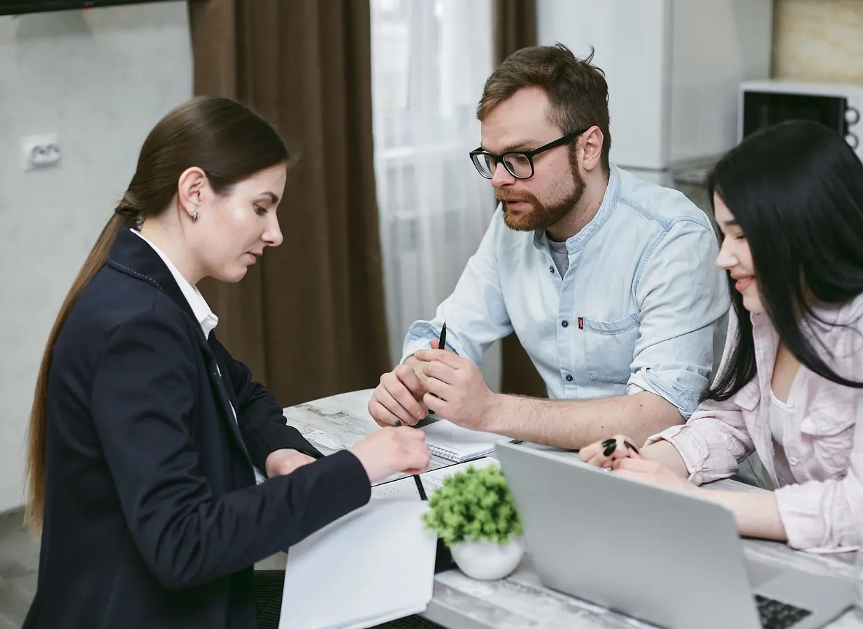 Couple reviewing financial documents with an advisor during a simple mortgage meaning discussion