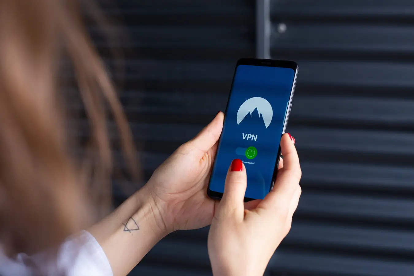 Close-up of a woman using a smartphone security app, highlighting Samsung password manager concerns