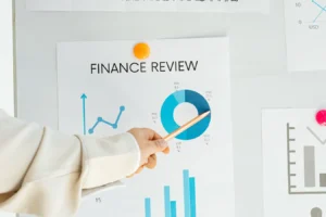 Hand pointing at finance report with charts and graphs for pipe revenue-based financing article