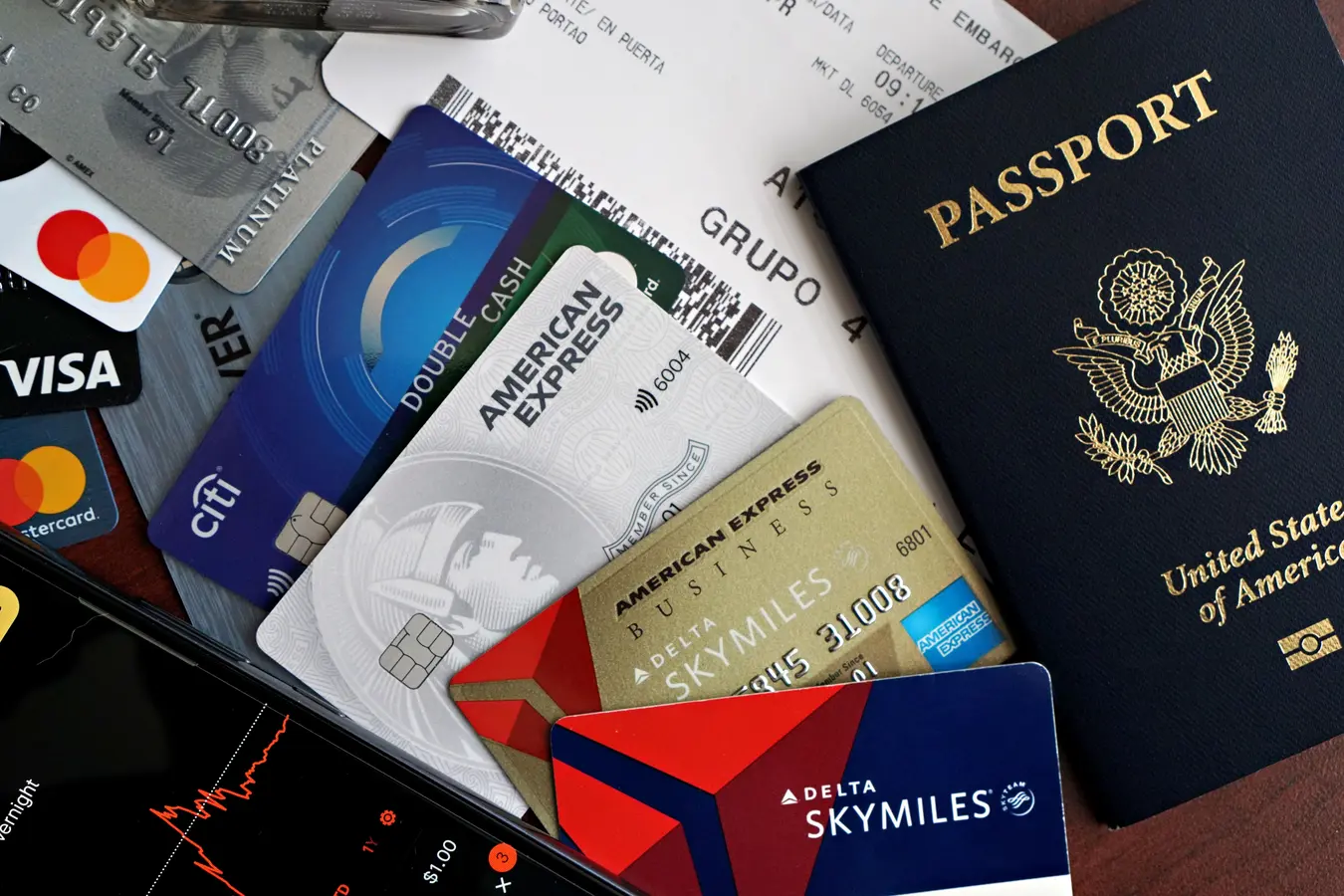 Passport, credit cards, and boarding pass arranged as travel essentials for premium credit card travel