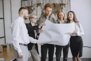 Professionals in an office analyzing project plans in a software project management meeting
