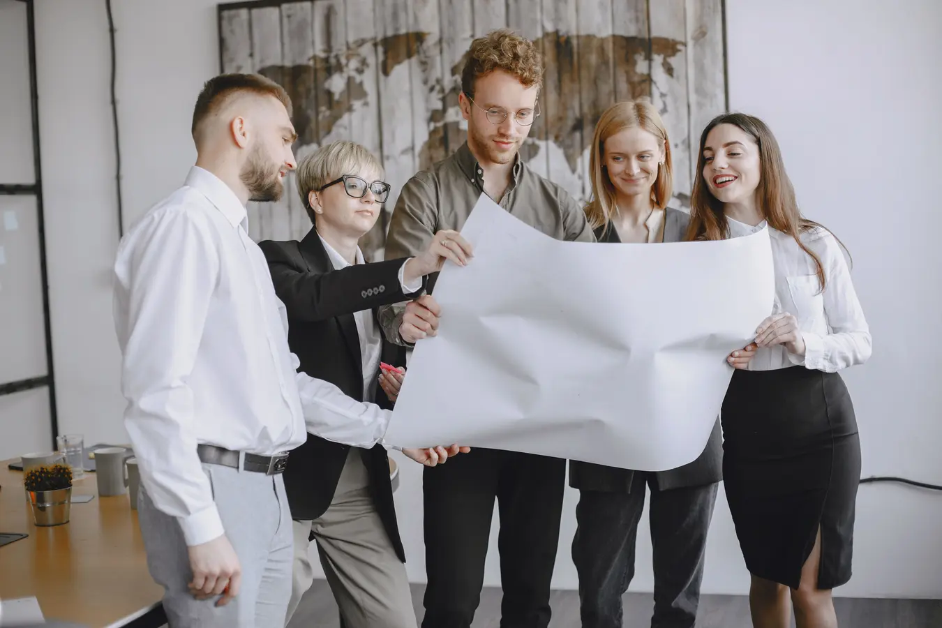 Professionals in an office analyzing project plans in a software project management meeting