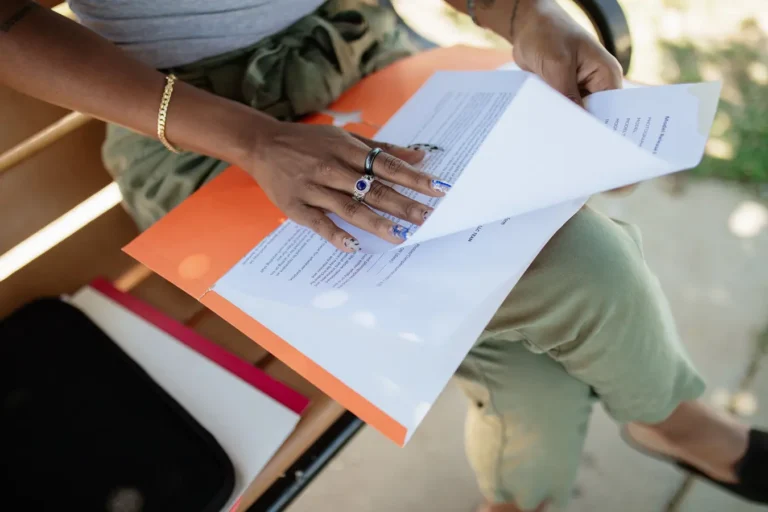 Woman reviewing documents on a bench in natural light, related to puisne mortgage pronunciation