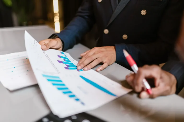 Professionals reviewing financial graphs during a business meeting on ESG investing trends