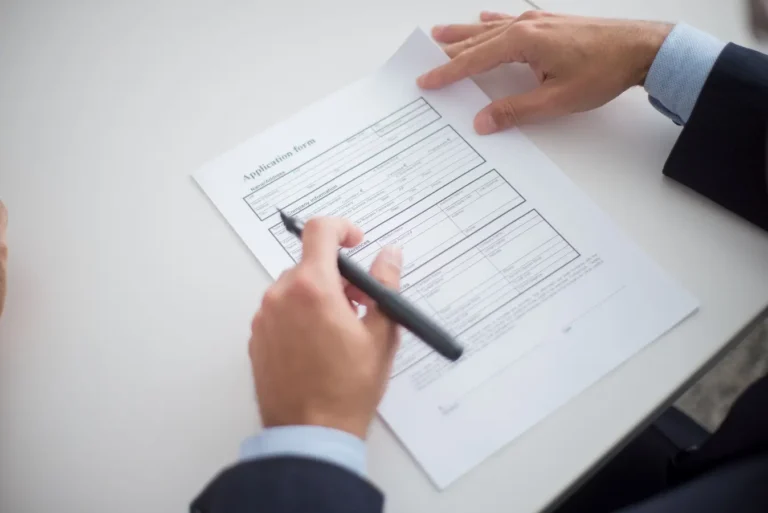 Business professional reviewing a loan application form at a desk