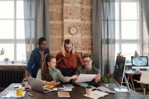 Diverse team collaborating on business strategy in an urban office, similar to Trello software project management