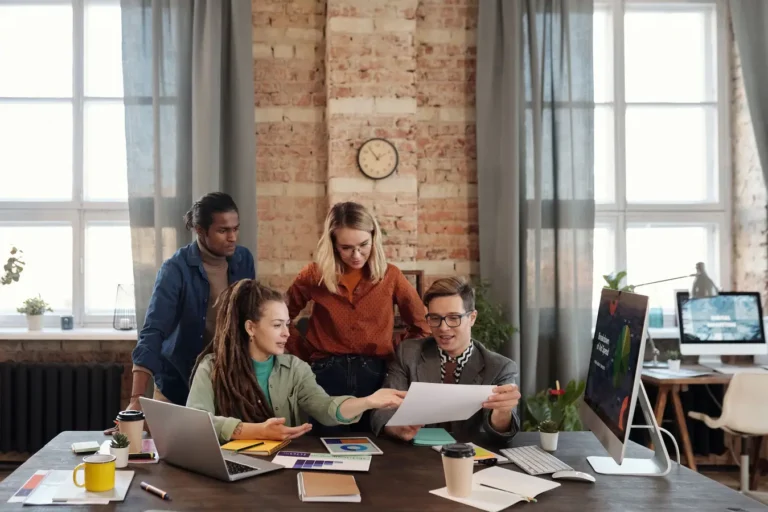 Diverse team collaborating on business strategy in an urban office, similar to Trello software project management
