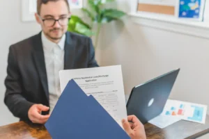 Mortgage broker and client discussing loan documents at a table for a Hindi mortgage guide